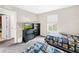 Bedroom with two twin beds, dresser, and TV at 744 La Mirage St, Davenport, FL 33897