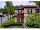 Two-story townhome with brown roof and tan exterior at 744 La Mirage St, Davenport, FL 33897