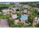 Aerial view of resort community with multiple pools, water slides, and lush landscaping at 744 La Mirage St, Davenport, FL 33897