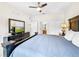 King-size bed, dresser, and ceiling fan in a spacious bedroom at 744 La Mirage St, Davenport, FL 33897