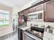 Modern kitchen with stainless steel appliances and granite countertops at 744 La Mirage St, Davenport, FL 33897