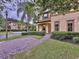 Brick pathway leading to two-story townhome entrance at 744 La Mirage St, Davenport, FL 33897
