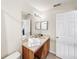 Bathroom with wood vanity, sink, and toilet at 744 La Mirage St, Davenport, FL 33897