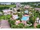 Aerial view of resort showing pools, a water slide, and palm trees at 744 La Mirage St, Davenport, FL 33897