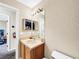 Small bathroom with single sink vanity, toilet and mirror at 744 La Mirage St, Davenport, FL 33897