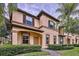 Tan townhome with brown accents and lush landscaping at 744 La Mirage St, Davenport, FL 33897