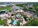 Expansive pool area with multiple pools, palm trees, and lounge chairs at 744 La Mirage St, Davenport, FL 33897