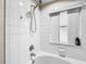 Bathroom with shower/tub combo and white tile at 744 La Mirage St, Davenport, FL 33897