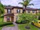 Two-story house with brown roof and landscaping at 744 La Mirage St, Davenport, FL 33897