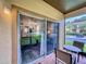 Screened patio with table and chairs, overlooking backyard at 744 La Mirage St, Davenport, FL 33897