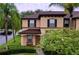 Two-story house with brown roof and landscaping at 744 La Mirage St, Davenport, FL 33897