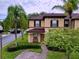 Two-story townhome with a brick paver driveway and landscaping at 744 La Mirage St, Davenport, FL 33897