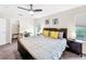 King bed, nightstands, ceiling fan, large windows at 744 La Mirage St, Davenport, FL 33897