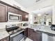 Modern kitchen with stainless steel appliances and granite countertops at 744 La Mirage St, Davenport, FL 33897