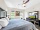 Spacious bedroom with a king-size bed, dresser, and ceiling fan at 744 La Mirage St, Davenport, FL 33897
