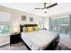 King-size bed, balcony access, ceiling fan at 744 La Mirage St, Davenport, FL 33897