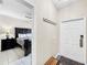 Bright entryway with bench and view into bedroom at 744 La Mirage St, Davenport, FL 33897