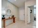 Light and airy entryway with console table and mirror at 12922 Trovita Dr, Grand Island, FL 32735