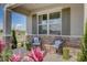 Inviting front porch with seating and landscaping at 12922 Trovita Dr, Grand Island, FL 32735