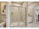 Large walk-in shower with glass enclosure and neutral tile at 12922 Trovita Dr, Grand Island, FL 32735