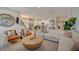 Open concept living area with a sectional sofa, kitchen views, and stylish decor at 12922 Trovita Dr, Grand Island, FL 32735