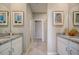 Double vanity bathroom with granite countertops and a walk-in shower at 12922 Trovita Dr, Grand Island, FL 32735