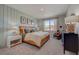 Spacious main bedroom with wood bed frame and neutral decor at 12922 Trovita Dr, Grand Island, FL 32735