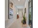 Bright and airy entryway with tile flooring, modern art, and a full-length mirror at 12922 Trovita Dr, Grand Island, FL 32735