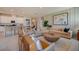 Open concept living room with a comfortable sectional sofa and views into the kitchen at 12922 Trovita Dr, Grand Island, FL 32735