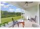 Screened porch overlooking a pond, with seating for two at 6316 Dolostone Dr, Lakeland, FL 33811