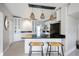 Modern kitchen with white cabinets and breakfast bar at 151 N Orlando Ave # 131, Winter Park, FL 32789