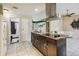 Modern kitchen with a large island, stainless steel appliances, and a view of the bathroom at 501 N Normandale Ave, Orlando, FL 32835