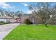 Brick house with red accents, a grassy lawn and driveway at 501 N Normandale Ave, Orlando, FL 32835