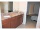 Double vanity bathroom with granite countertop and access to bedroom at 9054 Rhodes St, Kissimmee, FL 34747