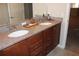 Double vanity bathroom with granite countertop and wood cabinets at 9054 Rhodes St, Kissimmee, FL 34747