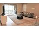 Living room with gray sectional sofa and access to patio at 9054 Rhodes St, Kissimmee, FL 34747