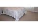 Simple bedroom with carpeted floor and floral bedding at 9054 Rhodes St, Kissimmee, FL 34747
