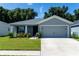 Gray house with two-car garage and well-manicured lawn at 3882 Willow Ridge Dr, Lakeland, FL 33810