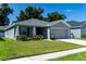 Gray house with two-car garage and well-manicured lawn at 3882 Willow Ridge Dr, Lakeland, FL 33810
