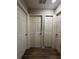 Hallway with multiple doors and wood-look floors at 3882 Willow Ridge Dr, Lakeland, FL 33810
