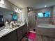 Double vanity bathroom with a shower and tub at 3882 Willow Ridge Dr, Lakeland, FL 33810