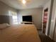 Spacious bedroom with large bed, TV, and access to another room at 3882 Willow Ridge Dr, Lakeland, FL 33810