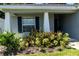 Front entrance with navy blue shutters and lush shrubs at 3882 Willow Ridge Dr, Lakeland, FL 33810