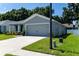 Gray house with a two-car garage and a well-maintained lawn at 3882 Willow Ridge Dr, Lakeland, FL 33810