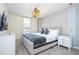 Bright bedroom featuring a king-size bed, modern decor, and a window with blinds at 1692 Tropical Palms Cir, Kissimmee, FL 34747