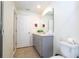 Clean bathroom with vanity, sink, toilet, and gray cabinets at 1692 Tropical Palms Cir, Kissimmee, FL 34747
