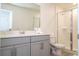 Modern bathroom with gray vanity, shower, and toilet at 1692 Tropical Palms Cir, Kissimmee, FL 34747
