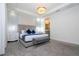Main bedroom with king-size bed, gray carpet, and ensuite bathroom access at 1692 Tropical Palms Cir, Kissimmee, FL 34747