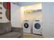 Well-lit laundry closet with washer and dryer at 1692 Tropical Palms Cir, Kissimmee, FL 34747