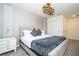 King bedroom with gray bedding, chandelier, and textured wall at 1692 Tropical Palms Cir, Kissimmee, FL 34747